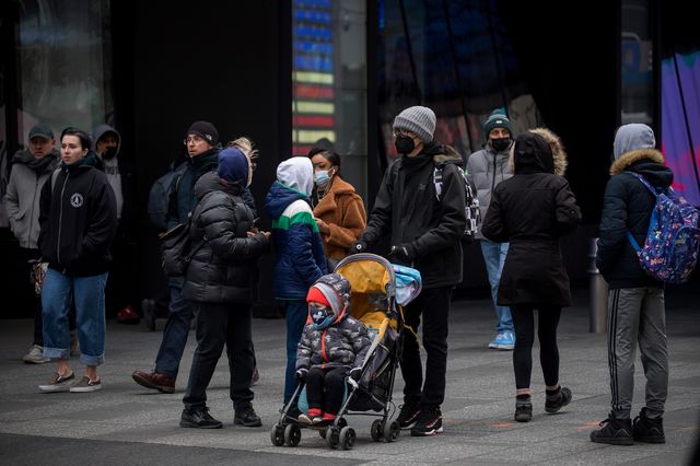 People walk in Times Square in New York, March 28, 2022.
